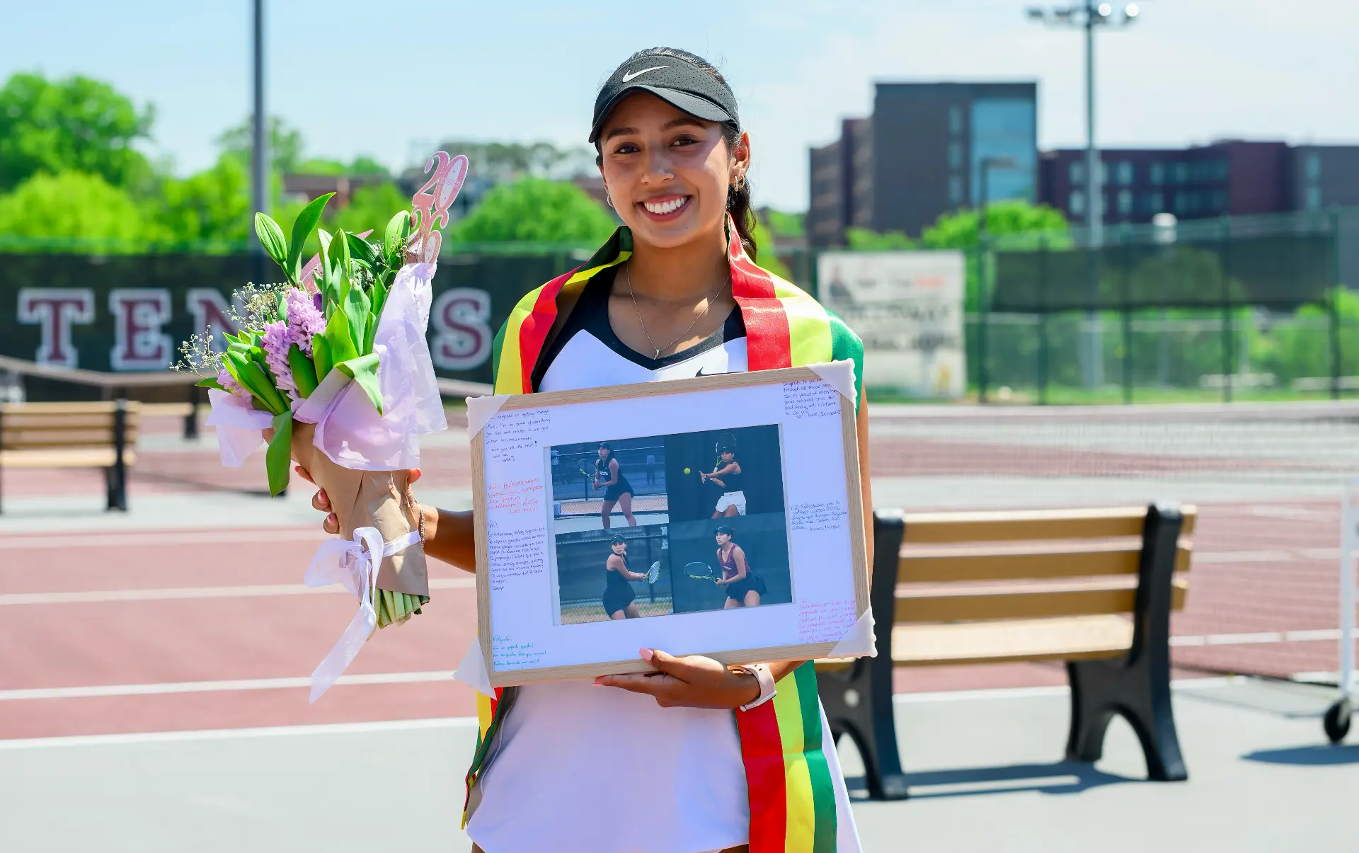 Valeria on her senior day with flowers and the Bolivian flag